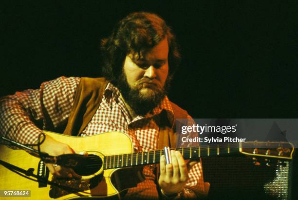 American bluegrass musician Merle Watson playing slide guitar during a concert at the Gaumont, Kilburn, London, 10th November 1977. He was performing...