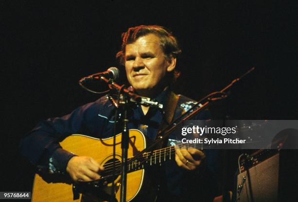 American bluegrass musician Doc Watson performing at a concert at the Gaumont, Kilburn, London, 10th November 1977. He was performing with his son...