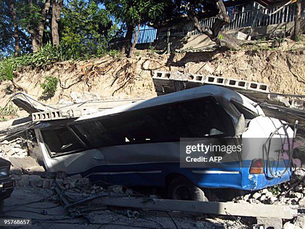 Destroyed vehicle in ruin on January 13, 2010 in Port-au-Prince, Haiti. Planeloads of rescuers and relief supplies headed to Haiti Wednesday as...