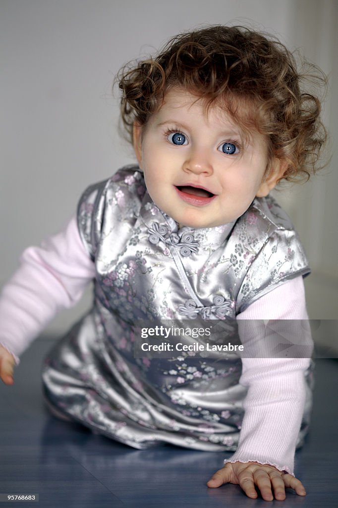 Baby girl crawling and smiling