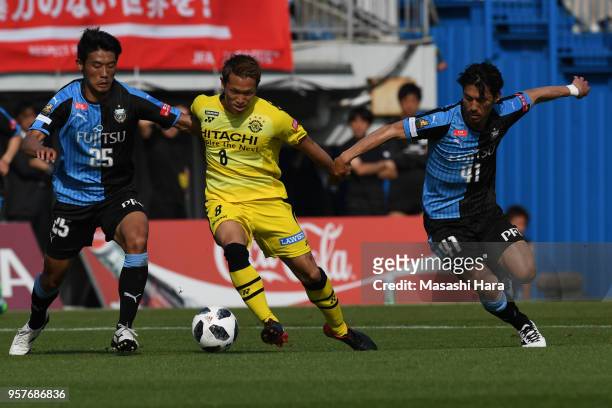 Kei Koizumi of Kashiwa Reysol ,Hidemasa Morita and Akihiro Ienaga of Kawasaki Frontale compete for the ball during the J.League J1 match between...