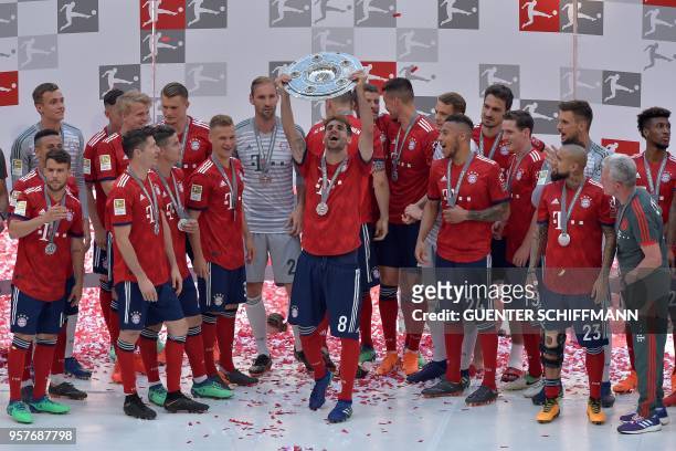 Bayern Munich's Spanish midfielder Javier Martinez lifts the trophy at the end of the German first division Bundesliga football match FC Bayern...
