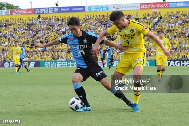 Yuto Suzuki of Kawasaki Frontale and Cristiano of Kashiwa Reysol compete for the ball during the J.League J1 match between Kashiwa Reysol and...