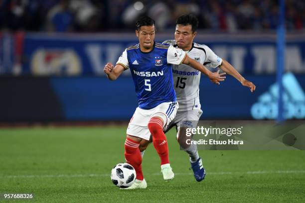 Takuya Kida of Yokohama F.Marinos and Yasuyuki Konno of Gamba Osaka compete for the ball during the J.League J1 match between Yokohama F.Marinos and...