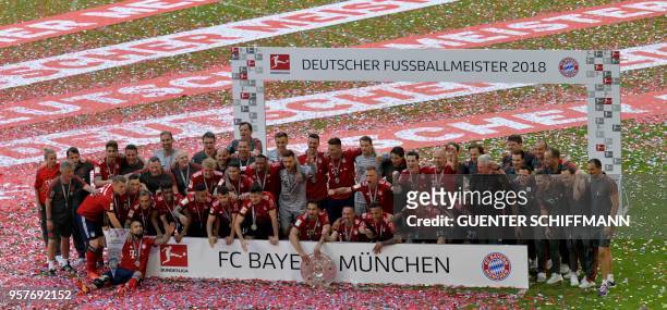Bayern Munich's players pose with their trophy after their victory at the end of the German first division Bundesliga football match FC Bayern Munich...