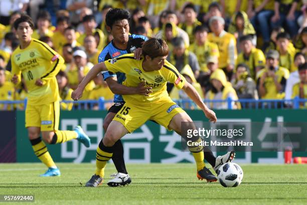 Kim Bo Kyung of Kashiwa Reysol and Hidemasa Morita of Kawasaki Frontale compete for the ball during the J.League J1 match between Kashiwa Reysol and...