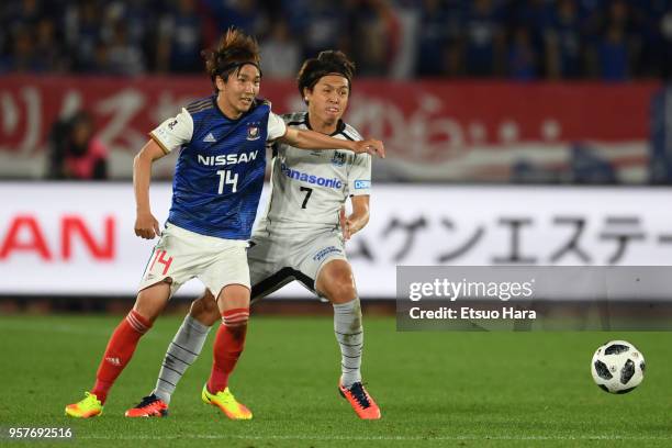 Jun Amano of Yokohama F.Marinos and Yusuhito Endo of Gamba Osaka compete for the ball during the J.League J1 match between Yokohama F.Marinos and...