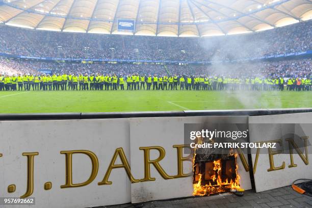 Display burns after Hamburg supporters throw fireworks during the German first division Bundesliga football match Hamburger SV vs Borussia...