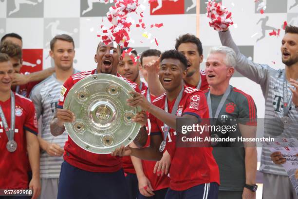 Jerome Boateng and David Alaba of Bayern Muenchen lift the trophy during the Bundesliga match between FC Bayern Muenchen and VfB Stuttgart at Allianz...