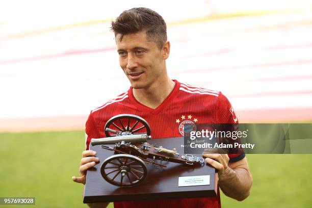 Robert Lewandowski of Bayern Muenchen hold the trophy for the top goalscorer of the season after the Bundesliga match between FC Bayern Muenchen and...