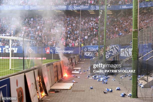 An display burns after Hamburg supporters throw fireworks during the German first division Bundesliga football match Hamburger SV vs Borussia...