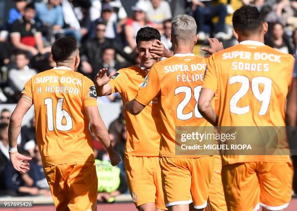 Porto's Spanish defender Ivan Marcano celebrates with teammates scoring a goal during the Portuguese league football match between Vitoria SC and FC...