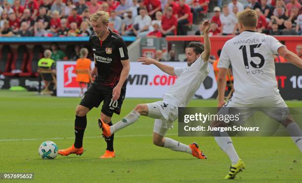 Julian Brandt of Leverkusen and Julian Korb of Hannover compete during the Bundesliga match between Bayer 04 Leverkusen and Hannover 96 at BayArena...