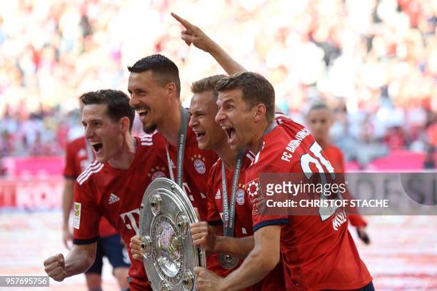 Bayern Munich's German midfielder Sebastian Rudy, forward Sandro Wagner, German midfielder Joshua Kimmich and German forward Thomas Mueller pose with...