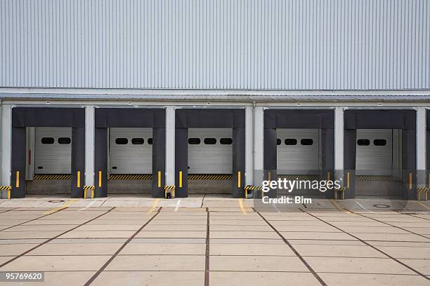 warehouse loading bays - industrial doors stock pictures, royalty-free photos & images