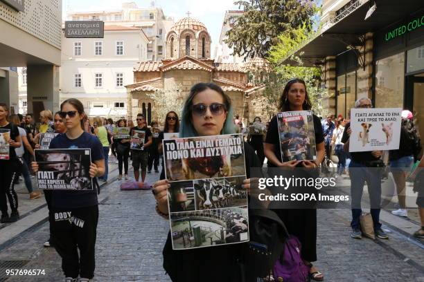 Protesters seen holding placards during the demonstration. Vegans demonstrate silently in Athens against animal abuse, the defense of maternity and...