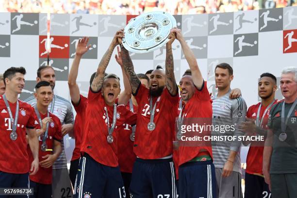 Bayern Munich's players lift the trophy during the celebration for the 28th German football championship after the German first division Bundesliga...