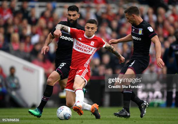 Adlene Guedioura of Middlesbrough runs with the ball under pressure from Mile Jedinak of Aston Villa and Conor Hourihane of Aston Villa during the...
