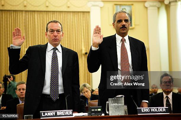 Attorney General Eric Holder and Assistant Attorney General Lanny Breuer of the Criminal Division are sworn in during a hearing before the Financial...