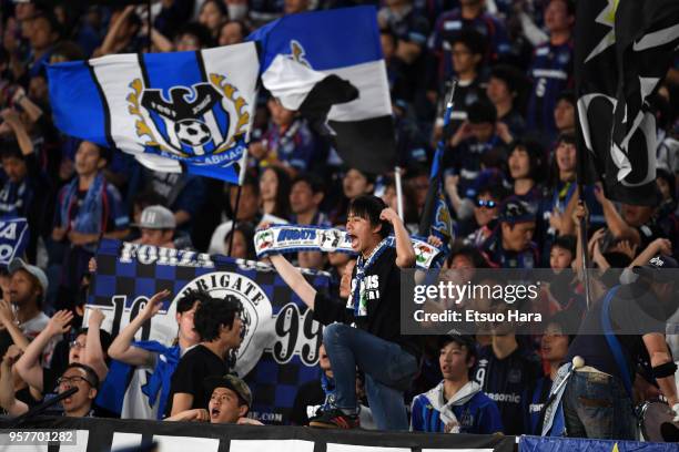 Fans of Gamba Osaka cheer during the J.League J1 match between Yokohama F.Marinos and Gamba Osaka at Nissan Stadium on May 12, 2018 in Yokohama,...