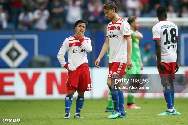 Tatsuya Ito, Albin Ekdal and Bakery Jatta of Hamburg react after their team is relegated after during the Bundesliga match between Hamburger SV and...