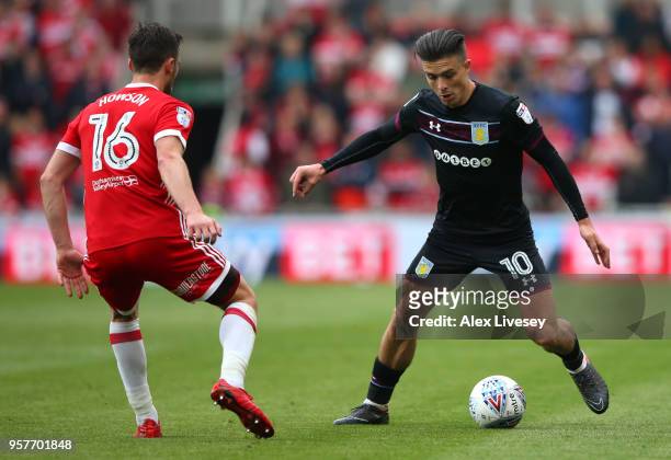 Jack Grealish of Aston Villa looks to run past Jonny Howson of Middlesbrough during the Sky Bet Championship Play Off Semi Final First Leg match...