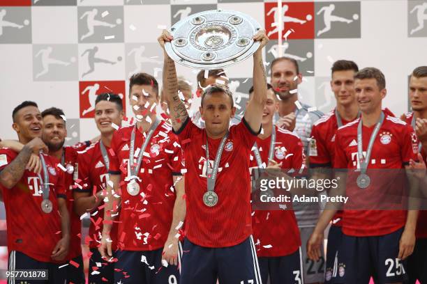 Rafinha of Bayern Muenchen lifts the Bundesliga trophy after the Bundesliga match between FC Bayern Muenchen and VfB Stuttgart at Allianz Arena on...