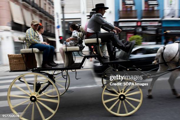 People seen in Reyes Catolicos Street in Granada riding a cart before take part in the procession of El Rocio. The Romeria del Rocio is one of the...