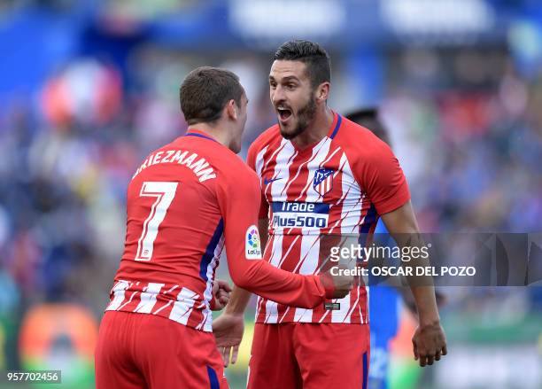 Atletico Madrid's Spanish midfield Koke celebrates a goal with Atletico Madrid's French forward Antoine Griezmann during the Spanish league football...