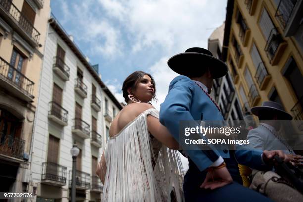 Two belivers riding a horse during procession of El Rocio in Granada. The Romeria del Rocio is one of the most popular festivities in Andalusia,...