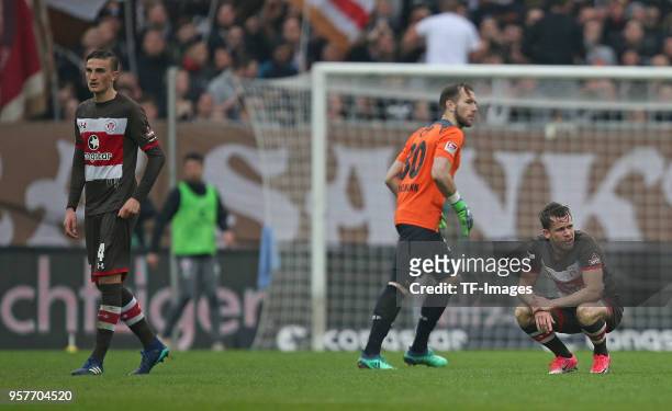 Philipp Ziereis of St. Pauli, Goalkeeper Robin Himmelmann of St. Pauli and Christopher Buchtmann of St. Pauli look dejected during the Second...