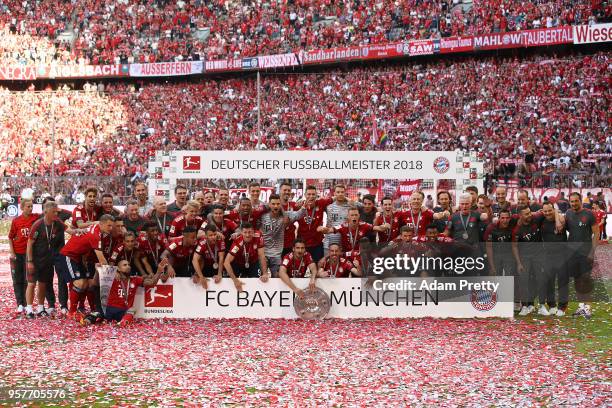 Players of Munechen and staff pose with the champions trophy after the Bundesliga match between FC Bayern Muenchen and VfB Stuttgart at Allianz Arena...