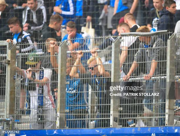 Hamburg's supporters react after the German first division Bundesliga football match Hamburger SV vs Borussia Moenchengladbach, in Hamburg, nothern...