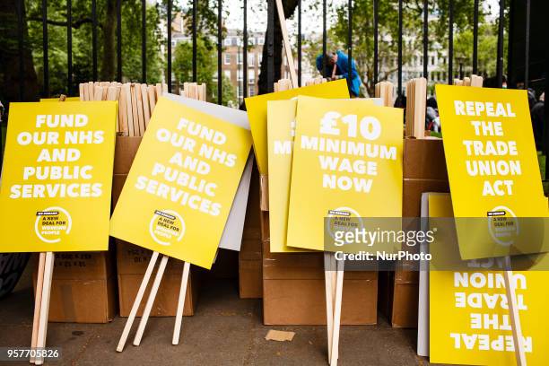 Placards rest against railings as demonstrators calling for fairer pay and rights for workers, as well as against public service cuts and workplace...