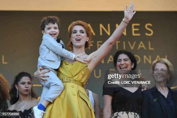 French director Eva Husson poses with her son Gaspard as she arrives on May 12, 2018 for the screening of her film "Girls of the Sun " at the 71st...