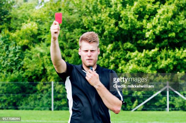 sports referee shows red card after blowing his whistle - red card stock pictures, royalty-free photos & images