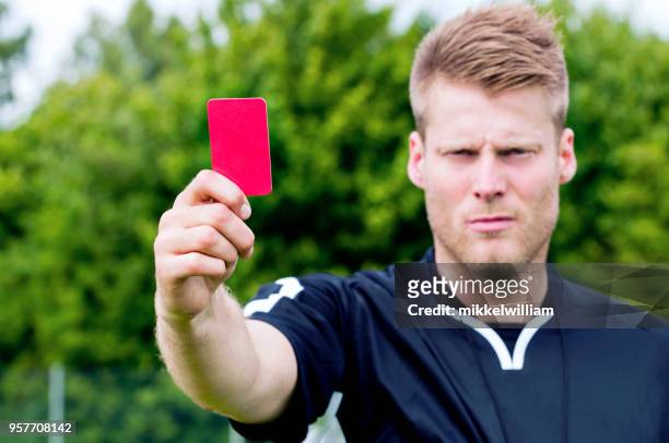 sports referee shows red card after blowing his whistle - red card stock pictures, royalty-free photos & images