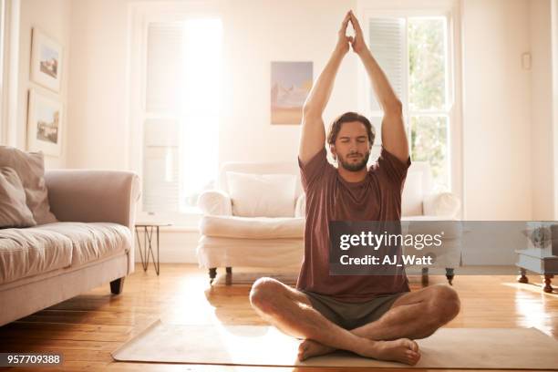meditating has made him a much calmer person - yoga home stock pictures, royalty-free photos & images