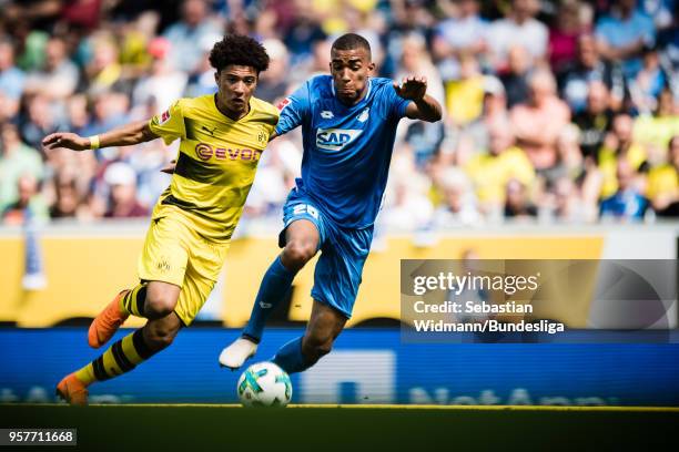 Jadon Malik Sancho of Dortmund and Kevin Akpoguma of Hoffenheim compete for the ball during the Bundesliga match between TSG 1899 Hoffenheim and...