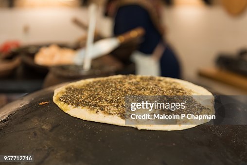 Manouche, Lebanese flatbread, with Zaatar mande on traditional stove, Beirut, Lebanon Manouche, Lebanese flatbread, with Zaatar mande on traditional stove, Beirut, Lebanon