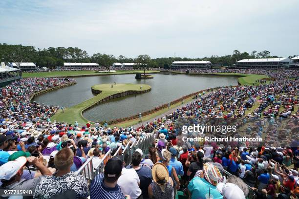 Tiger Woods of the United States putts on the 17th green during the third round of THE PLAYERS Championship on the Stadium Course at TPC Sawgrass on...
