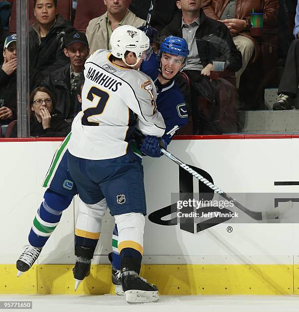 Dan Hamhuis of the Nashville Predators checks Alex Burrows of the Vancouver Canucks during their game at General Motors Place on January 11, 2010 in...