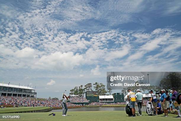 Tiger Woods of the United States plays his tee shot on the par 3, 17th hole during the third round of the THE PLAYERS Championship on the Stadium...