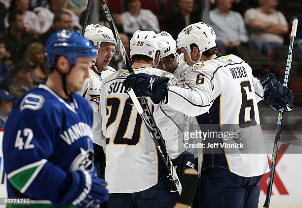 Kyle Wellwood of the Vancouver Canucks looks on dejected as members of the Nashville Predators celebrate a goal during their game at General Motors...