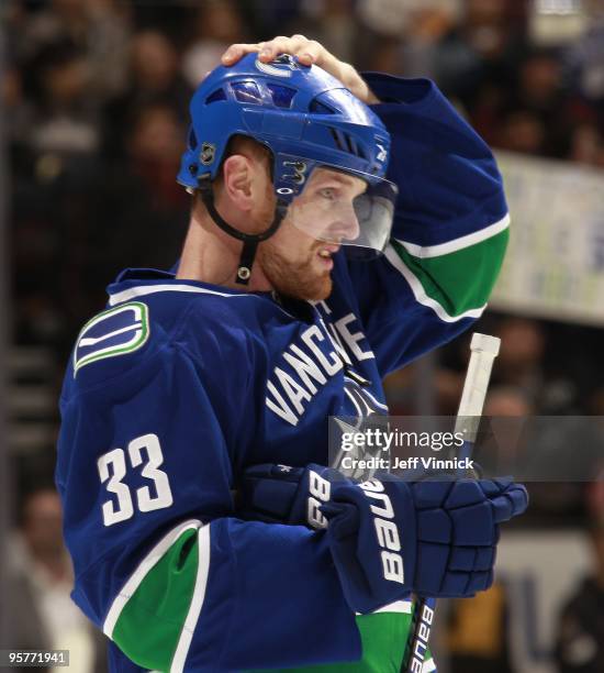 Henrik Sedin of the Vancouver Canucks adjusts his helmet during their game against the Nashville Predators at General Motors Place on January 11,...