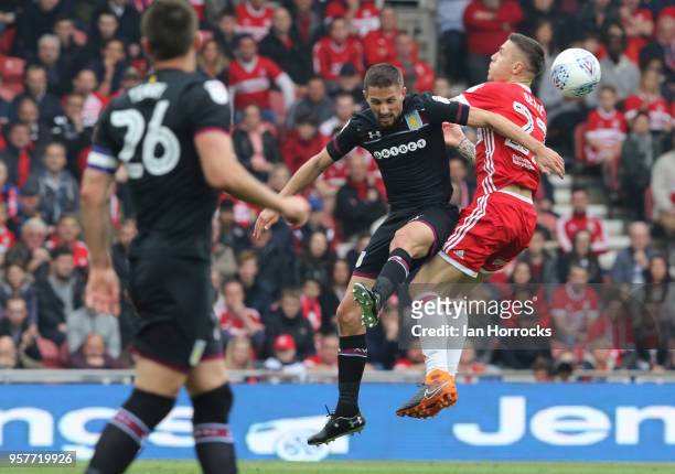 Conor Hourihane of Villa competes for a header with Muhamed Besic of Boro during the Sky Bet Championship Play Off Semi Final First Leg match between...