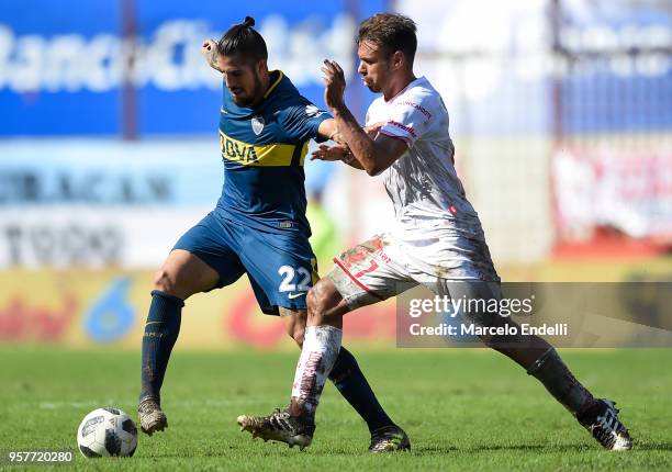 Junior Benitez of Boca Juniors fights for the ball with Adrian Calello of Huracan during a match between Huracan and Boca Juniors as part of...
