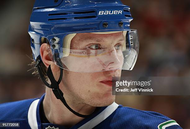 Christian Ehrhoff of the Vancouver Canucks looks on from the bench during their game against the Nashville Predators at General Motors Place on...