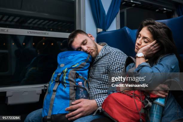 young couple sleeping in train during night - italy city break stock pictures, royalty-free photos & images