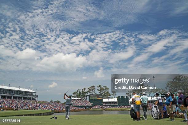 Tiger Woods of the United States plays his tee shot on the par 3, 17th hole during the third round of the THE PLAYERS Championship on the Stadium...